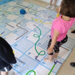 A watery “snakes & ladders” floor game